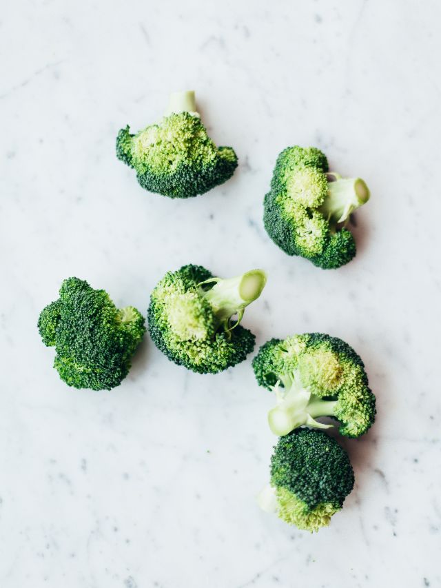 green broccoli on white surface