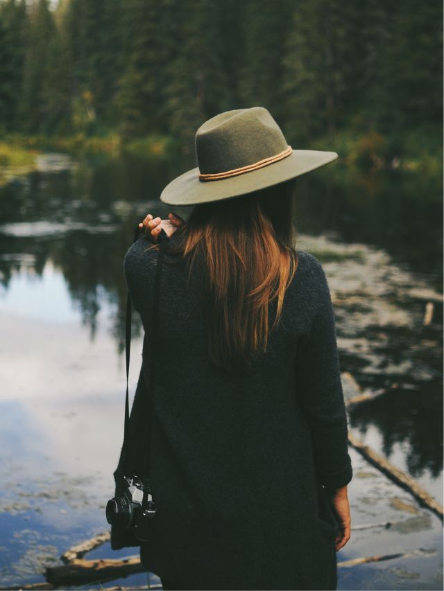 woman with camera at a lake