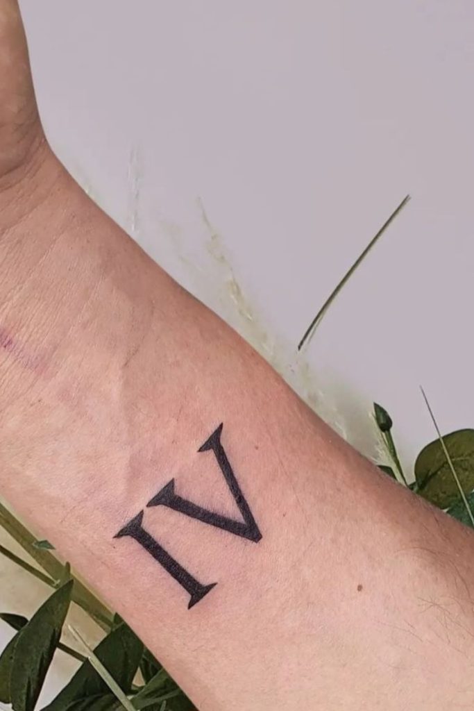 number 4 roman numeral tattoo on arm