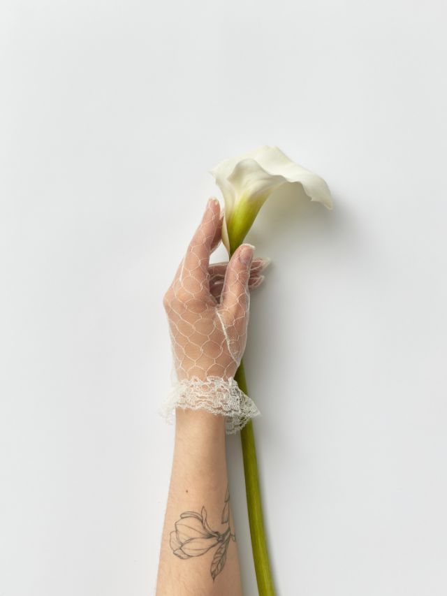 hand holding flower with flower tattoo
