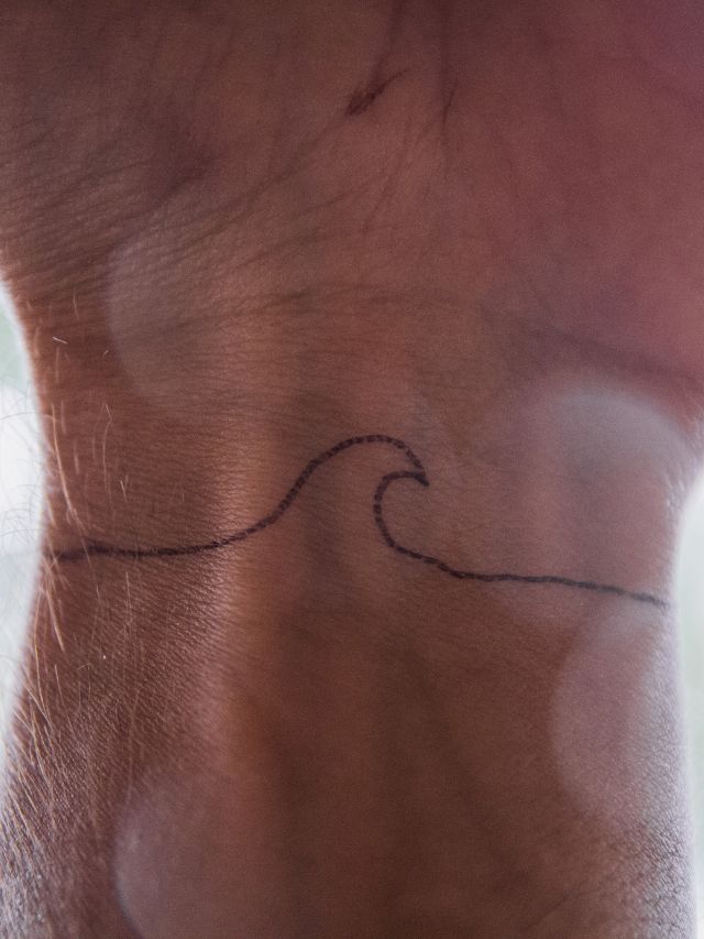 human hand with wave tattoo symbol tattoos with meaning