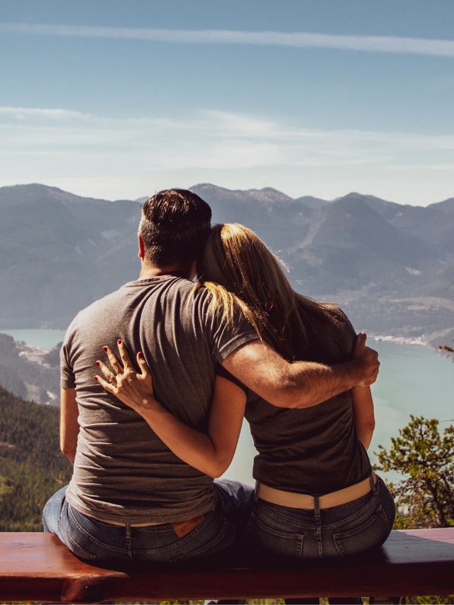 couple hugging while looking at mountain
