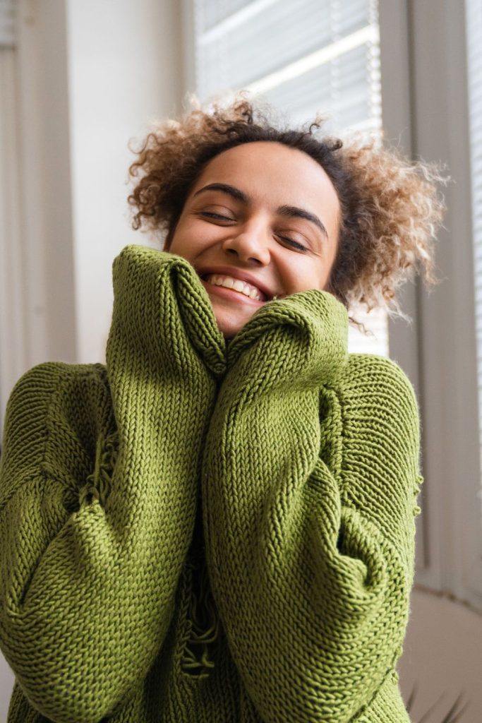 woman smiling with green sweater