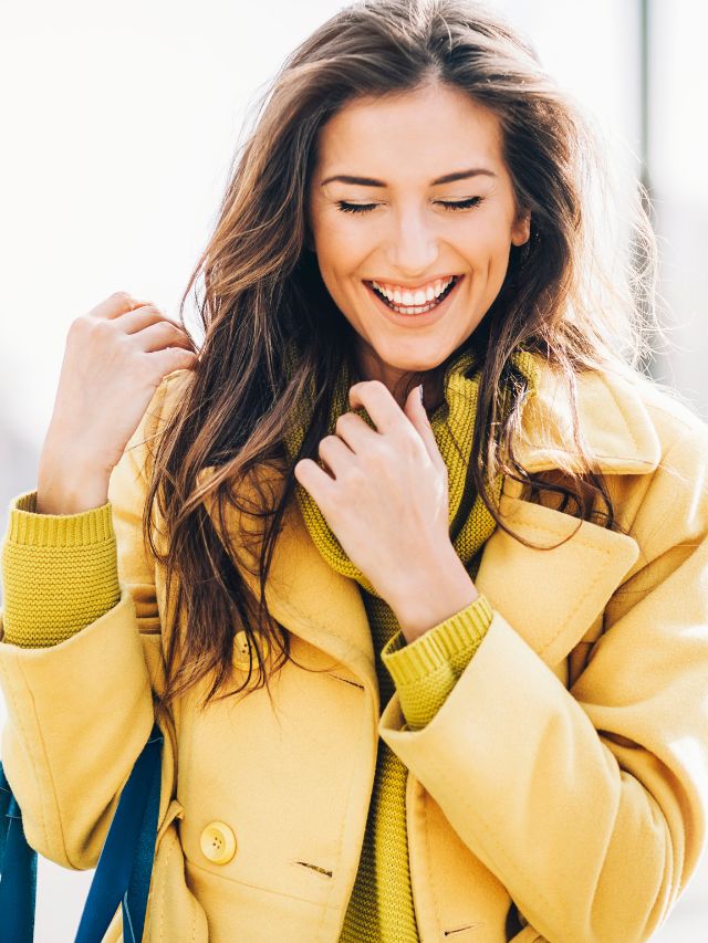 woman wearing yellow coat and sweater