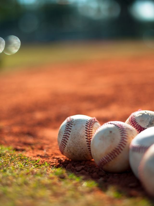 baseballs laying on a field