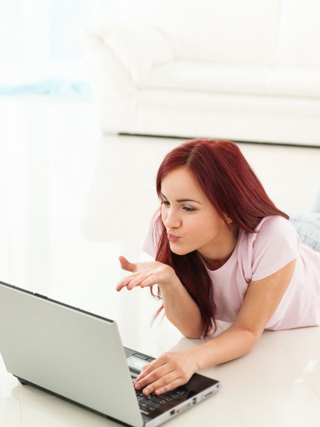 woman blowing a kiss to her laptop