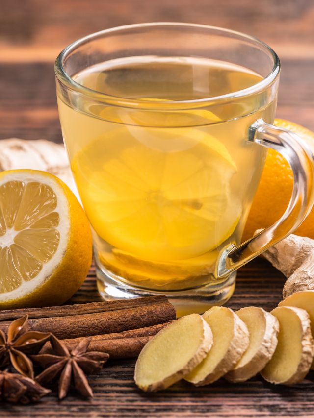 cup of ginger tea with lemon on wooden table