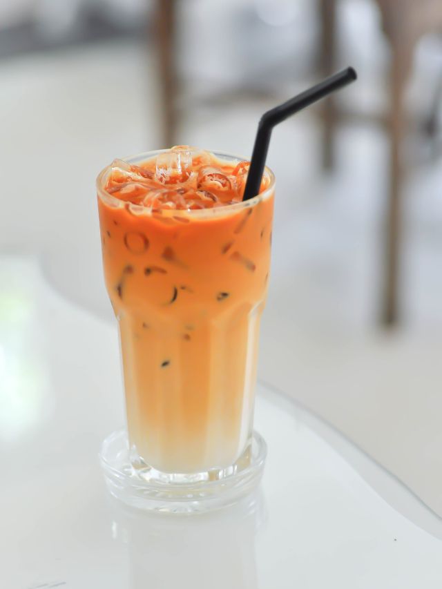 thai mil tea in glass with a straw