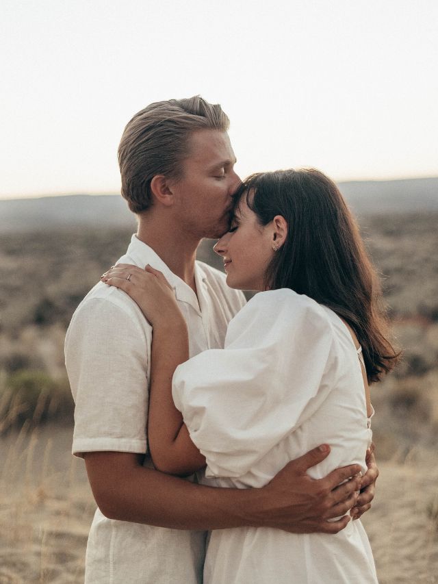 couple kissing in desert