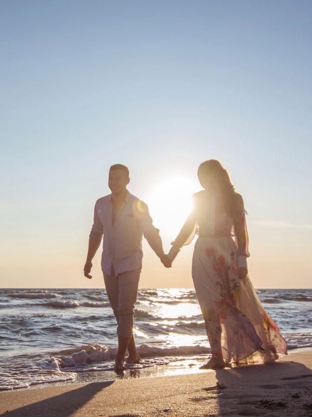 couple holding hands walking on the beach love manifestation affirmations