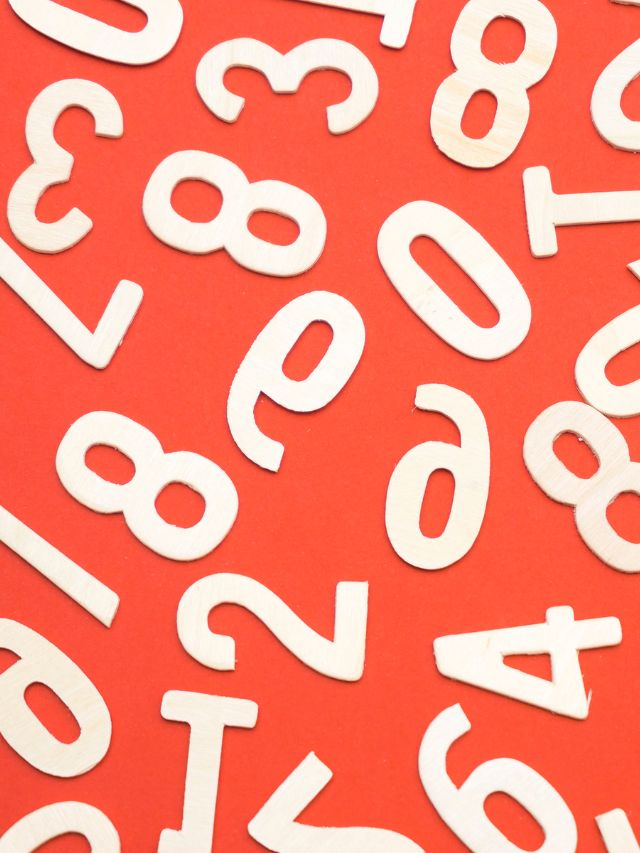 white wooden numbers on orange background