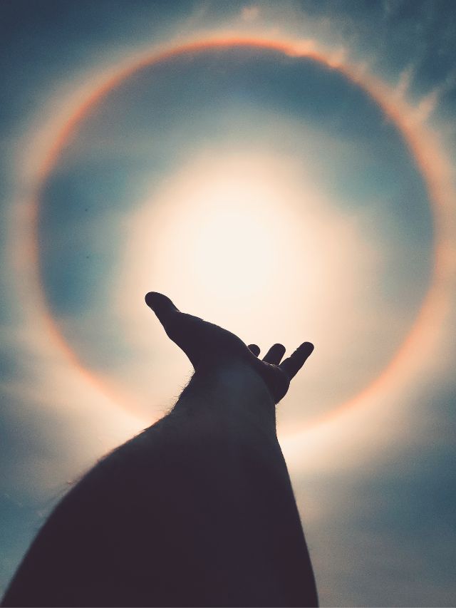 human hand reaching towards the light