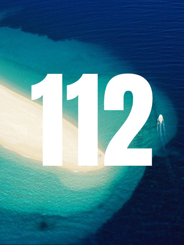 112 angel number on beach background