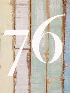 A wooden wall is adorned with the number 76, inviting curiosity about its significance and meaning.