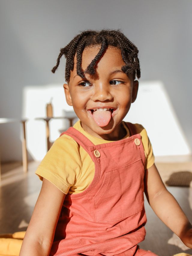 child sticking out tongue