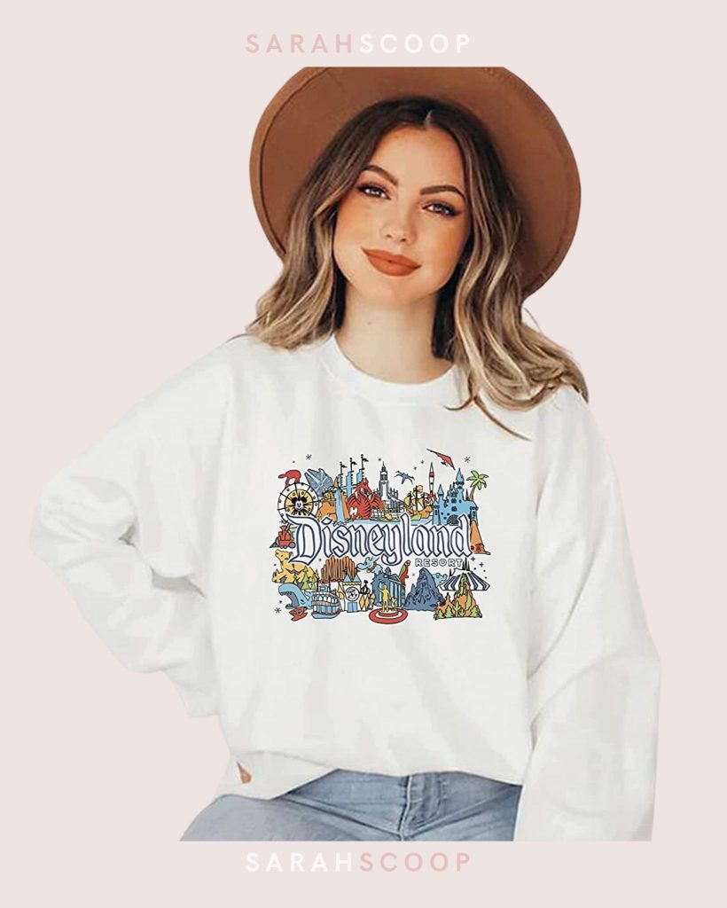 disneyland themed sweatshirt with famous disneyland attractionsn in vibrant colors on a white sweatshirt