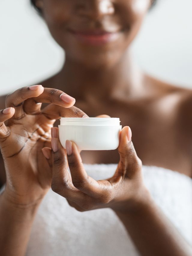 woman touching lotion in container