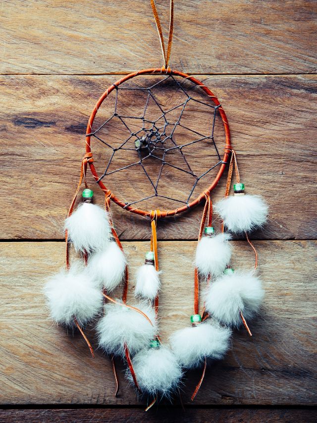 dream catcher laying on wooden table