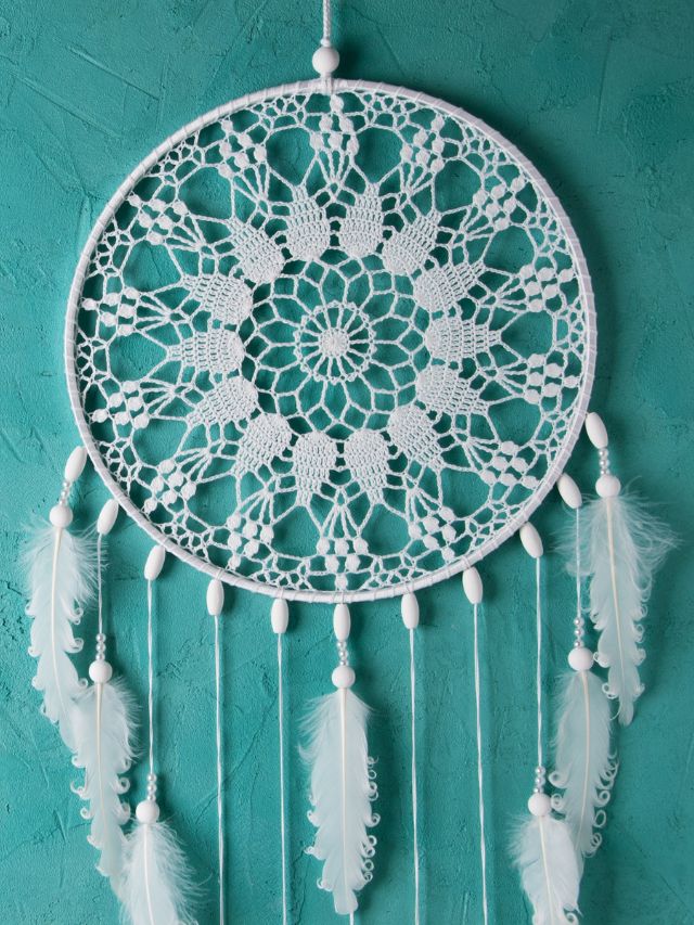 white dream catcher on turquoise background