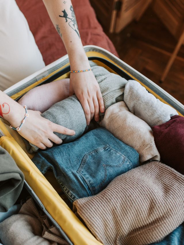 female hands packing suitcase