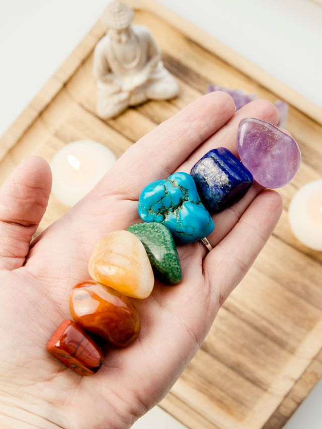 crystals laying in a line representing the colors of the chakra