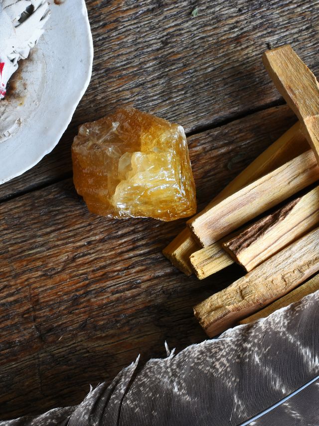 a single orange crystal on wooden table