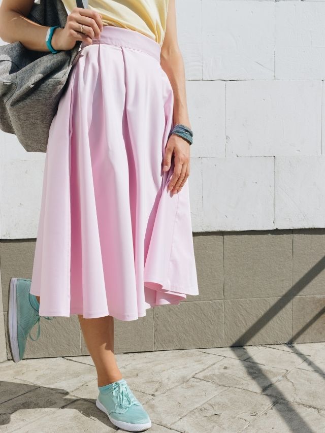 woman in skirt and sneakers