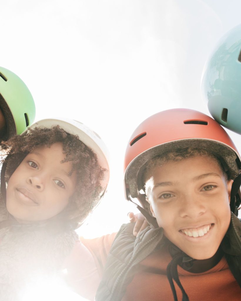 gift ideas for 10 year old boys featuring an a few boys wearing helmets in a huddle