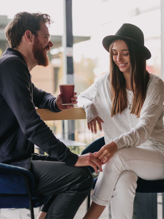 couple holding hands on coffee date