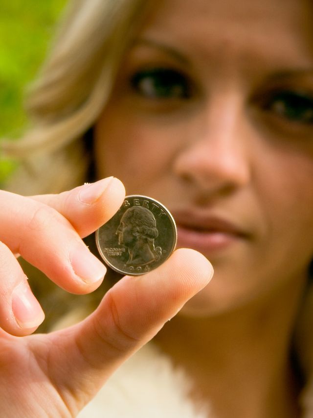 woman holding quarter