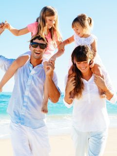 A beach family photoshoot with stylish outfits.