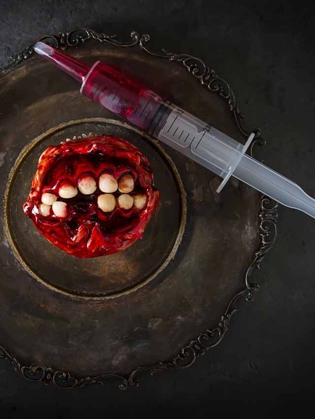 A plate with a syringe and blood on it.