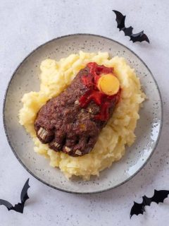 A plate with mashed potatoes and meat on it.