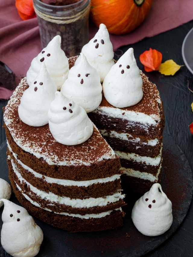 A slice of chocolate cake with ghosts on top.