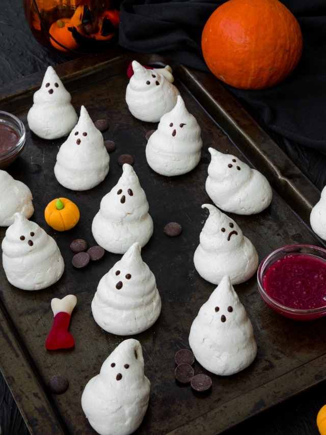 Halloween ghost cookies on a baking sheet.