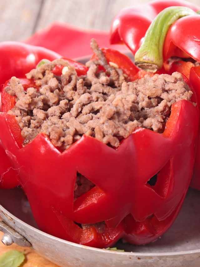 Stuffed red peppers with meat on a plate.