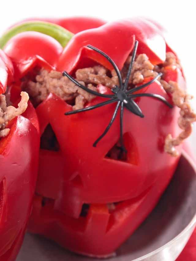 Two red peppers with spiders on them.