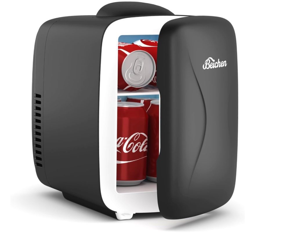 A black refrigerator with a can of coca cola inside.