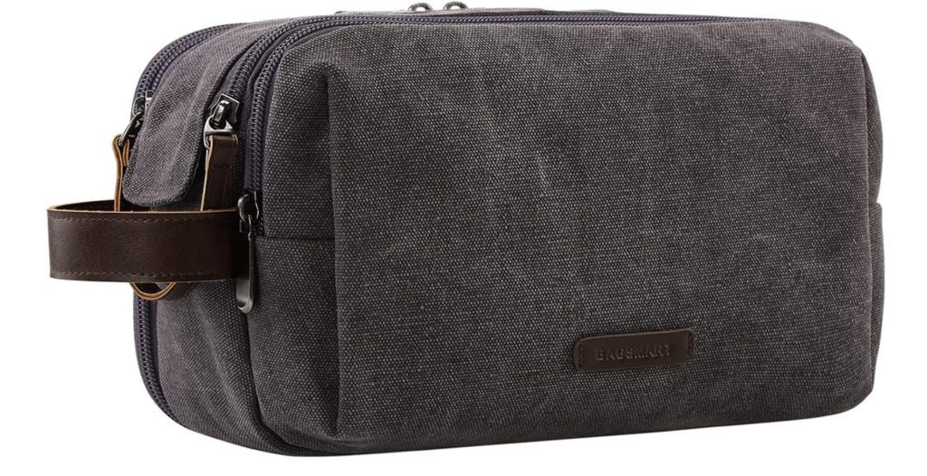 A grey canvas toiletry bag with a leather strap.