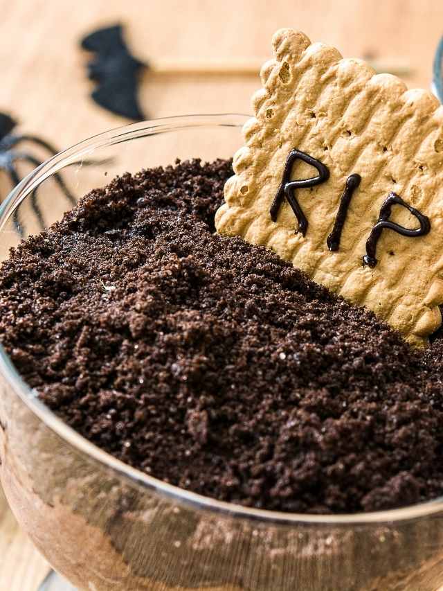 A glass bowl with a cookie in it and a sign that says rip.