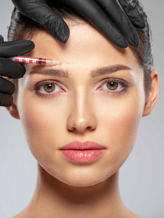 A woman getting a botox injection on her forehead.