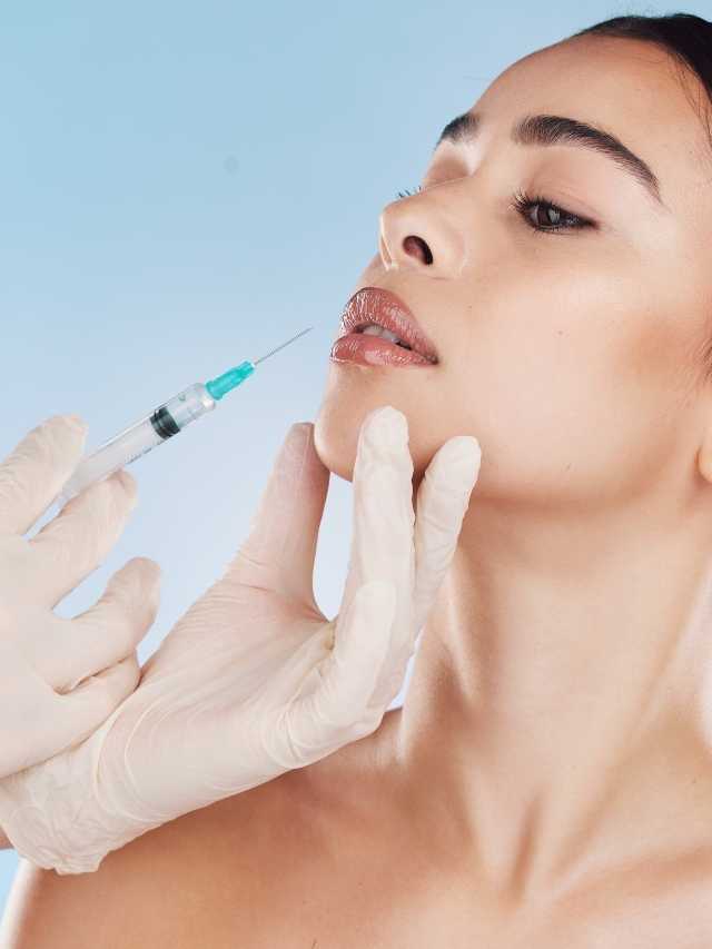 A woman getting a syringe injected into her face.