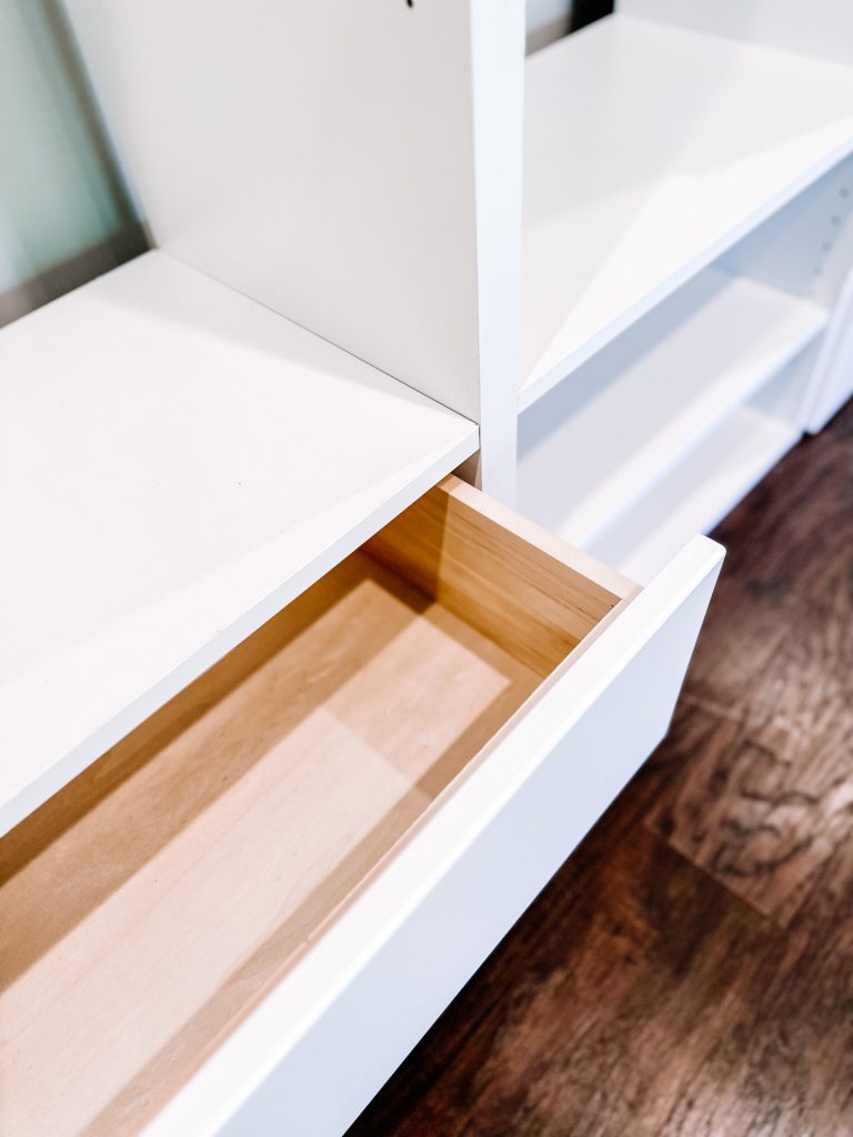 a drawer opening on a white modular closet