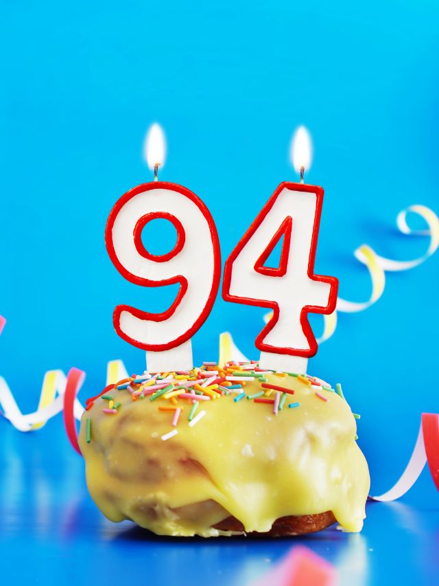 A donut decorated with the number 94.