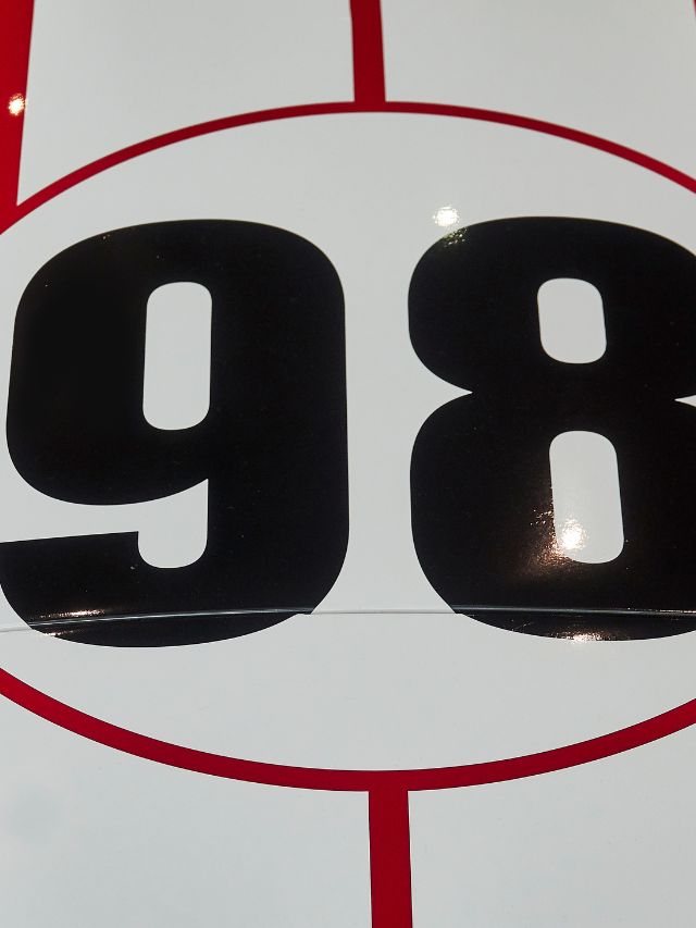 The number 98 is shown on a red and white circle.