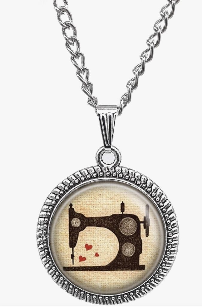 A festive Christmas gift idea for quilters is a sewing machine necklace adorned with hearts.