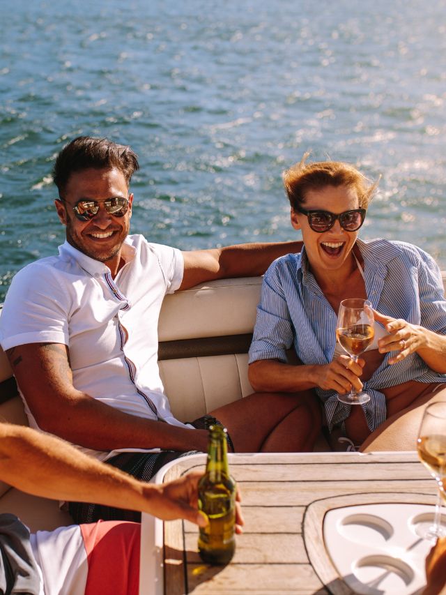 A group of boaters enjoying wine on a boat.