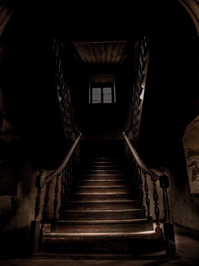 A dark staircase leading to a dark room.