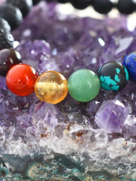A bracelet with different colored stones on top of crystals.