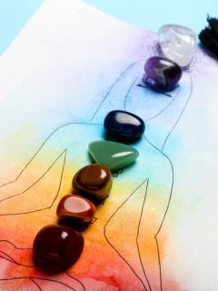 A drawing of the seven chakras with stones and a tassel.